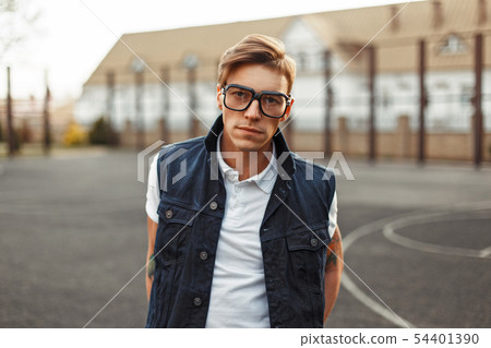 Stylish handsome man with glasses and a denim vest 54401390