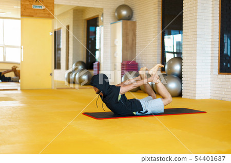 Young modern male practicing yoga Young modern male practicing yoga 54401687