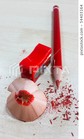Red pencil and sharpener, isolated on wood backgro 54403164