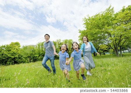 Four people playing in a fresh green park 54403866