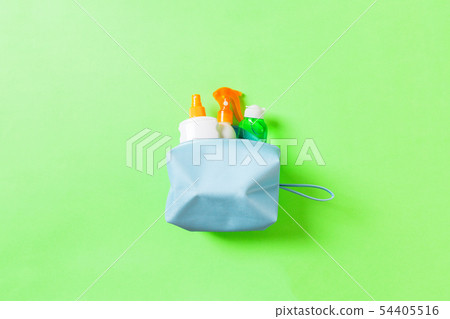 Top view of female cosmetics bag full of suncream 54405516