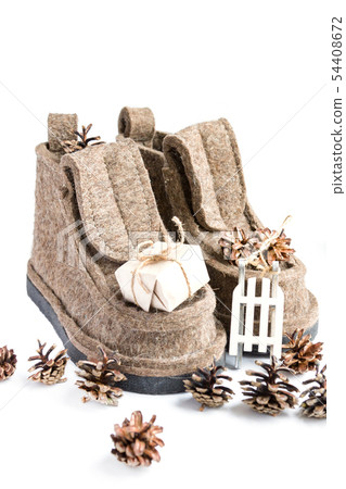 Winter felt boots, pine cones and present on white Winter felt boots, pine cones and present on white 54408672