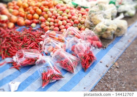 Shops selling vegetables at the market Shops selling vegetables at the market 54412707