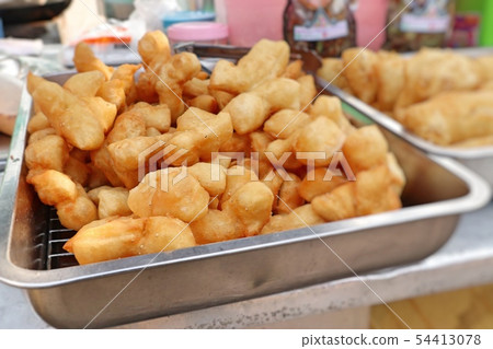 Deep-fried dough stick at market 54413078