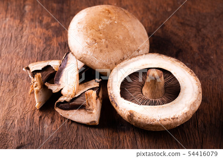 portobello mushrooms over old wood background portobello mushrooms over old wood background 54416079