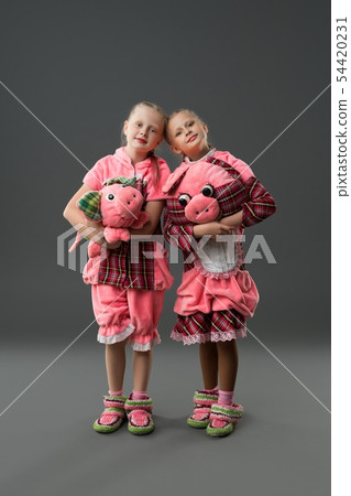 Girls in colorful dresses and knitted shoes view 54420231