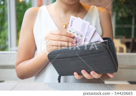 Asian women pick up Thai banknotes from the purse Asian women pick up Thai banknotes from the purse 54420665