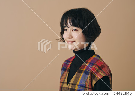 Young woman wearing a check dress Young woman wearing a check dress 54421940