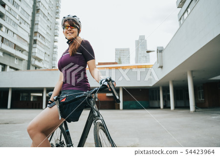 Man posing next to his bicycle. Man posing next to his bicycle. 54423964