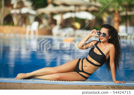 Beauty and body care. Sensual young woman relaxing in outdoor spa swimming pool Beauty and body care. Sensual young woman relaxing in outdoor spa swimming pool 54424715