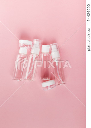 Travel small bottle set on a pink background. Top 54424900