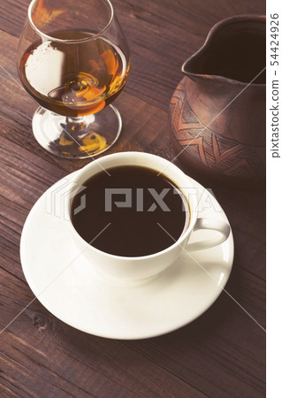 Coffee in white cup with cognac and clay cezve on Coffee in white cup with cognac and clay cezve on 54424926