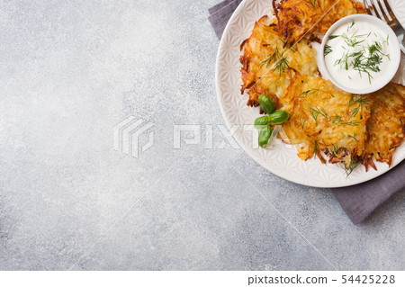 Fried cakes of grated potatoes on the plate  54425228