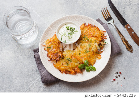Fried cakes of grated potatoes on the plate  54425229