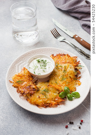 Fried cakes of grated potatoes on the plate  54425230