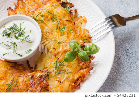 Fried cakes of grated potatoes on the plate  54425231