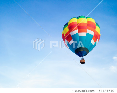 Hot air balloon in Flight with blue sky background 54425740