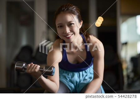 Gym woman dumbbells muscle workout 54428278