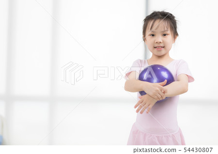 Asian girl in pink dress is holding ball.. Asian girl in pink dress is holding ball.. 54430807
