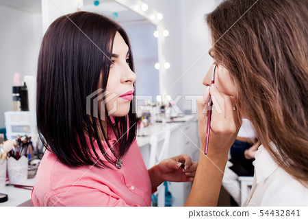 young, beautiful girl apply makeup on a eyebrows in a beauty salon 54432841