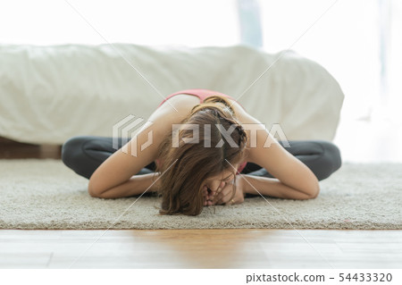 Asian Pregnant woman practice yoga in bedroom Asian Pregnant woman practice yoga in bedroom 54433320