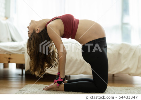 Asian Pregnant woman practice yoga in bedroom Asian Pregnant woman practice yoga in bedroom 54433347