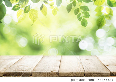 Empty table for present product with green bokeh Empty table for present product with green bokeh 54433385