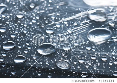 Close-up of raindrops of different sizes on the surface covered with cling film. Moisture weather 54434434
