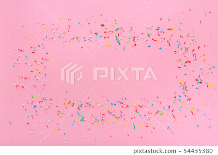 trendy frame of colorful sprinkles over pink trendy frame of colorful sprinkles over pink 54435380