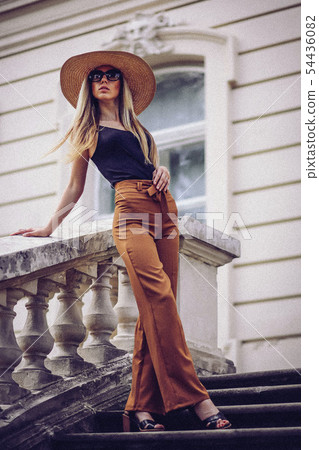 Noise. Vintage Style. Portrait of beautiful cool girl gesturing in hat and sunglasses over grunge Noise. Vintage Style. Portrait of beautiful cool girl gesturing in hat and sunglasses over grunge 54436082