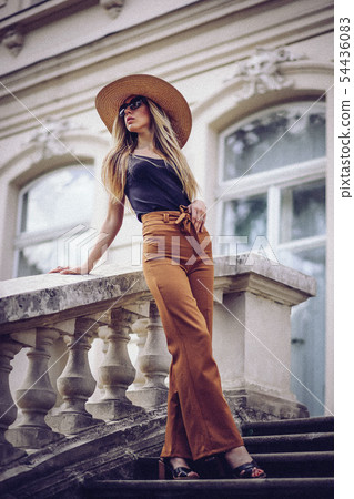 Noise. Vintage Style. Portrait of beautiful cool girl gesturing in hat and sunglasses over grunge 54436083