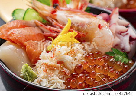 Bowl of rice topped with sashimi  54437643