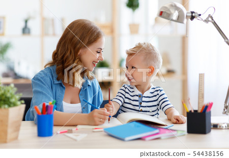 mother and child son doing homework writing and mother and child son doing homework writing and 54438156