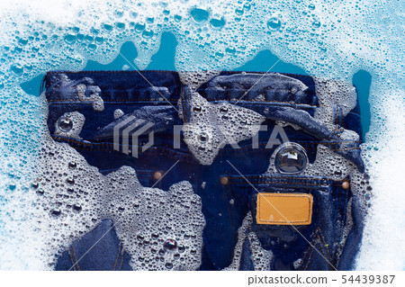 Jeans soak in powder detergent water dissolution. Jeans soak in powder detergent water dissolution. 54439387