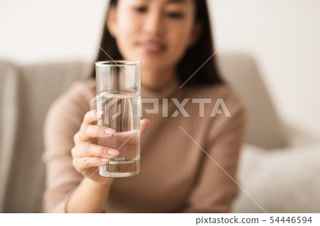 Asian Girl Holding Mineral Water In Glass 54446594