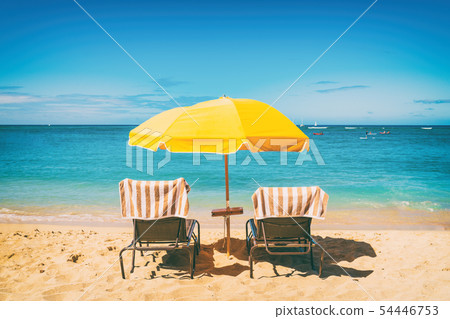 Beach holiday lounging chairs under sun umbrella vacation background. Summer tropical travel Beach holiday lounging chairs under sun umbrella vacation background. Summer tropical travel 54446753