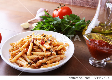 Spicy pasta penne bolognese with vegetables, chili and cheese in tomato sauce. Spicy pasta penne bolognese with vegetables, chili and cheese in tomato sauce. 54447323