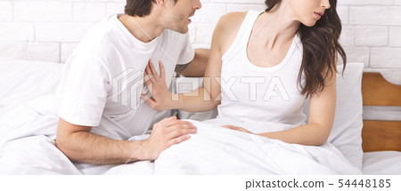 Young woman refusing her husband in bed, making stop sign 54448185