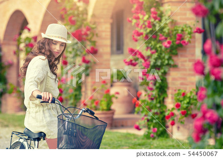 Woman in Tuscany garden. Summer time 54450067