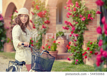 Woman in Tuscany garden. Summer time Woman in Tuscany garden. Summer time 54450068