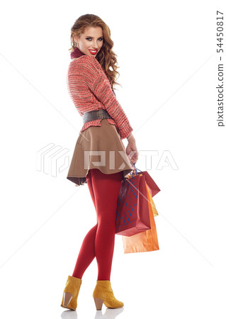 Young woman with shopping bags over white 54450817