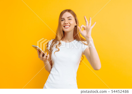 Portrait of a beautiful woman with a mobile phone Portrait of a beautiful woman with a mobile phone 54452486