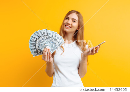 Portrait of an excited woman showing money bills Portrait of an excited woman showing money bills 54452605