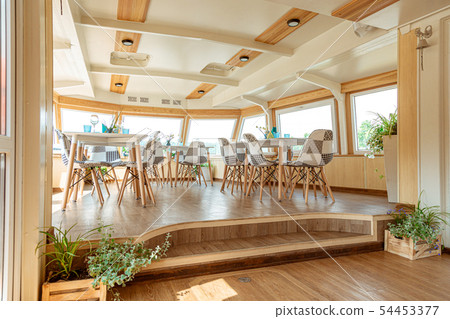 The interior of the urban river ship, with a panoramic view of the urban landscape. The concept of 54453377