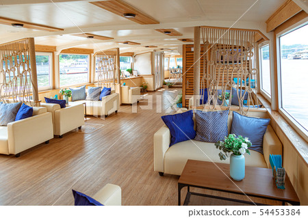The interior of the urban river ship, with a panoramic view of the urban landscape. The concept of The interior of the urban river ship, with a panoramic view of the urban landscape. The concept of 54453384