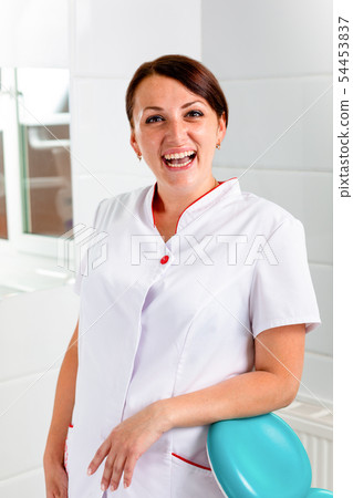 Beautiful, smiling dentist with tool in hand. Dentistry, dental treatment, health. Beautiful, smiling dentist with tool in hand. Dentistry, dental treatment, health. 54453837