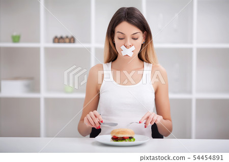 Unhealthy eating. Junk food concept. Girl don't eat junk food Unhealthy eating. Junk food concept. Girl don't eat junk food 54454891