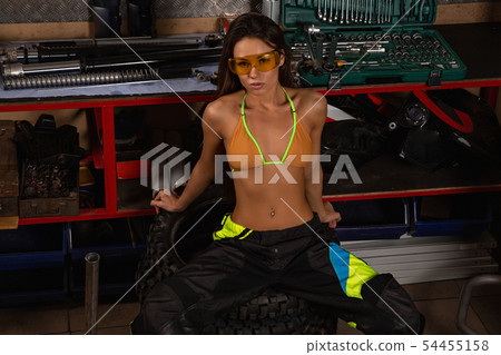 Sexy girl in garage with bike tires Sexy girl in garage with bike tires 54455158