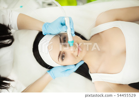 Body Care. Woman Receiving Face Skin Analysis. Cosmetology 54455529