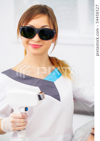 Rejuvenating facial treatment. Model getting lifting therapy massage in a beauty SPA salon Rejuvenating facial treatment. Model getting lifting therapy massage in a beauty SPA salon 54456527